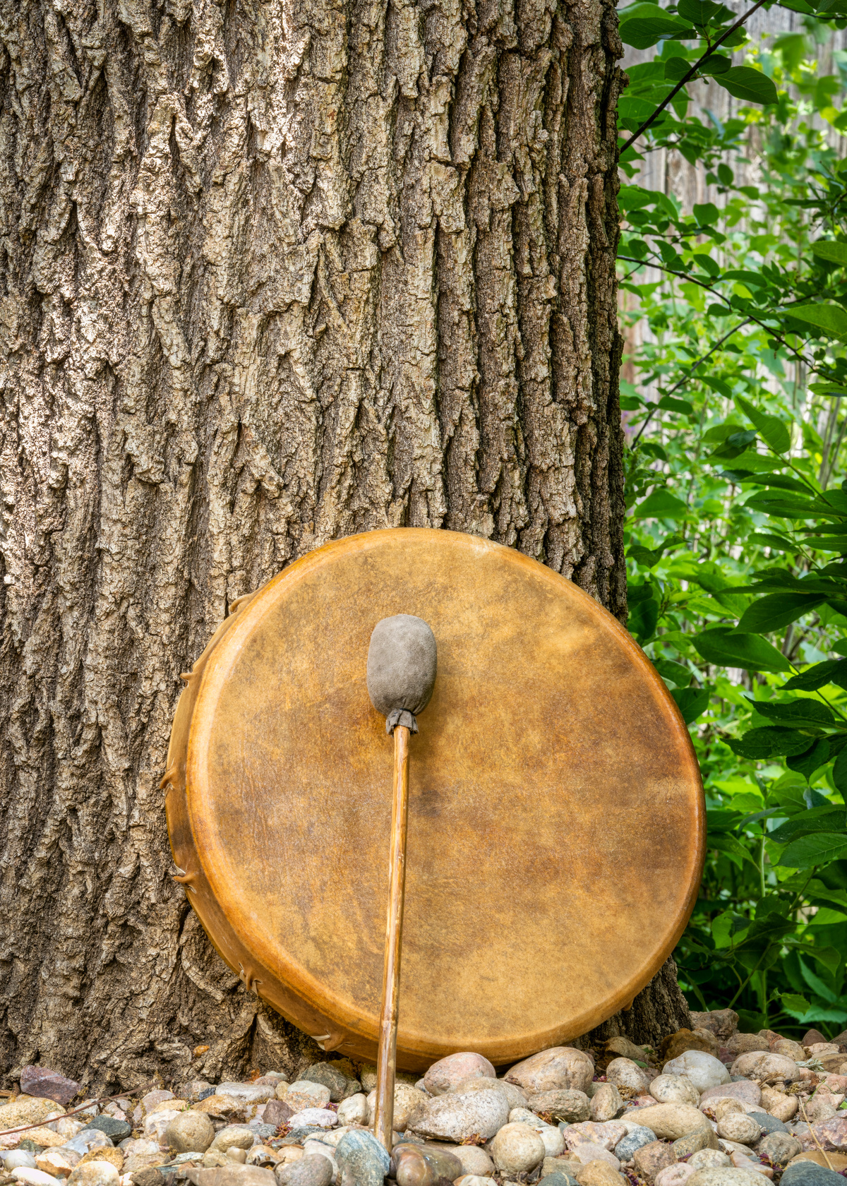 handmade, native American style, shaman frame drum covered by goat skin with a beater